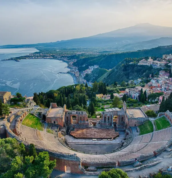 Aerial view of Greco-Roman Theatre and Mount Etna, Taormina, Sicily, Italy