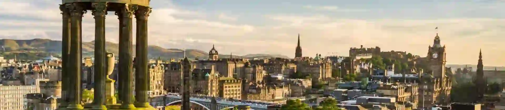 Edinburgh skyline at sunset from Calton Hill, with the Dugald Stewart Monument in the foreground
