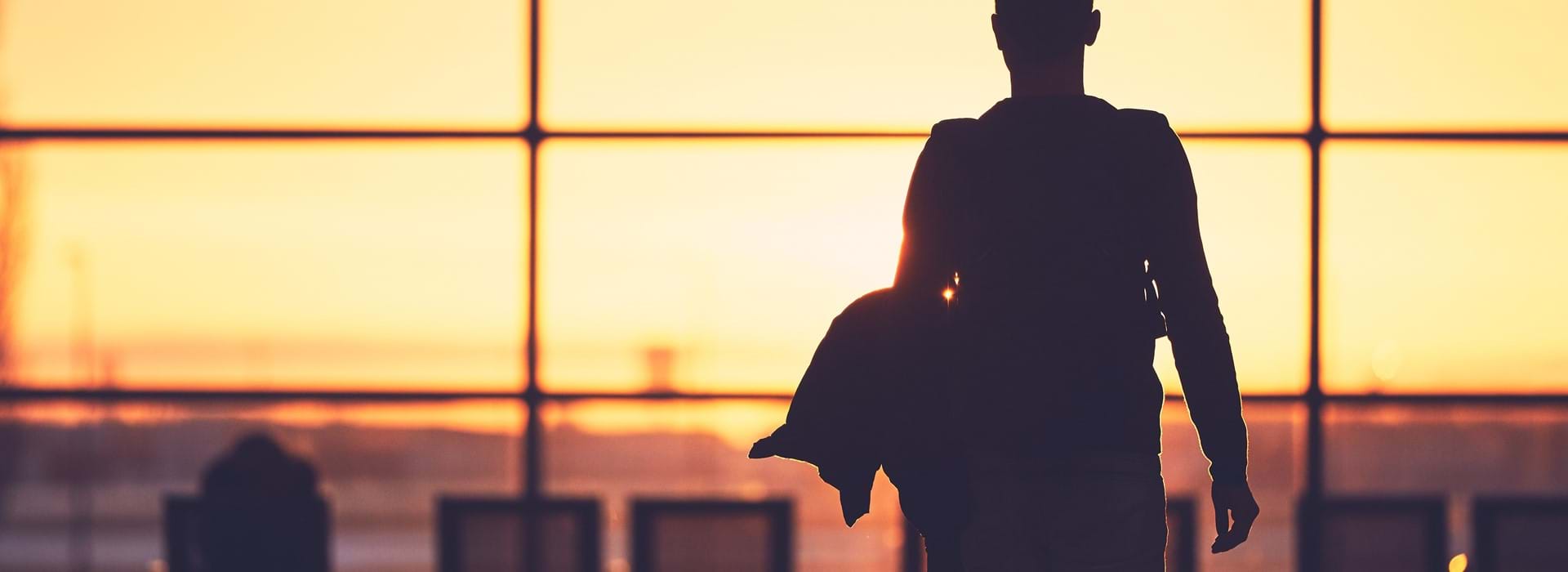 Person walking to departure gate in an airport