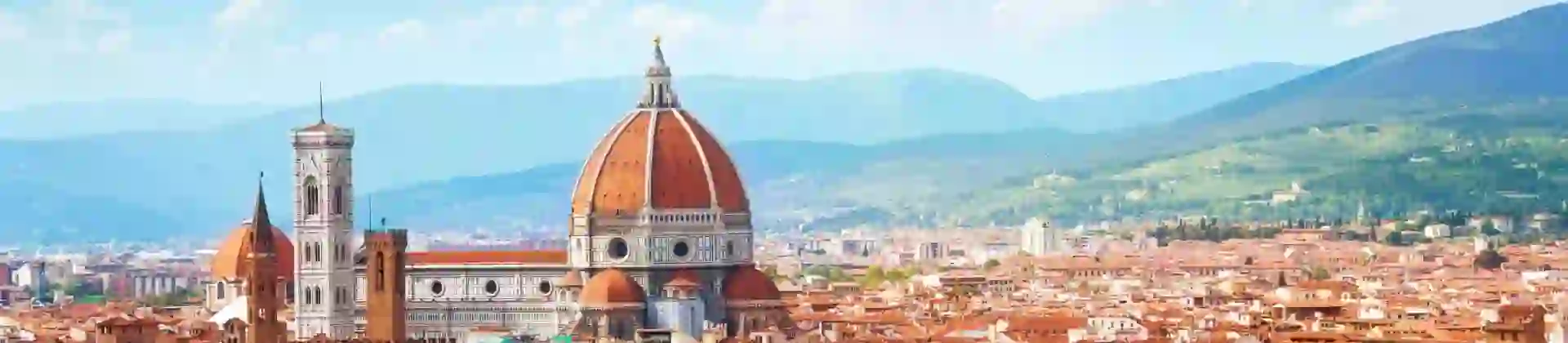 Panoramic view of Florence, Italy, with the Cathedral of Santa Maria del Fiore rising amongst the terracotta rooftops